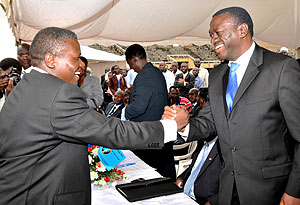 Norbert Mao shakes hands with Besigye